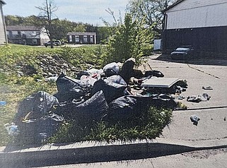 Courtesy/Cole County Health Department: 
A Health Department photo shows a pile of garbage outside an apartment complex on South Brooks Drive.